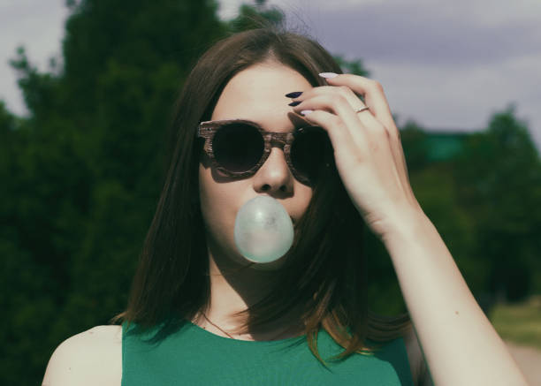 istock Young pretty girl chews a gum 695326044
