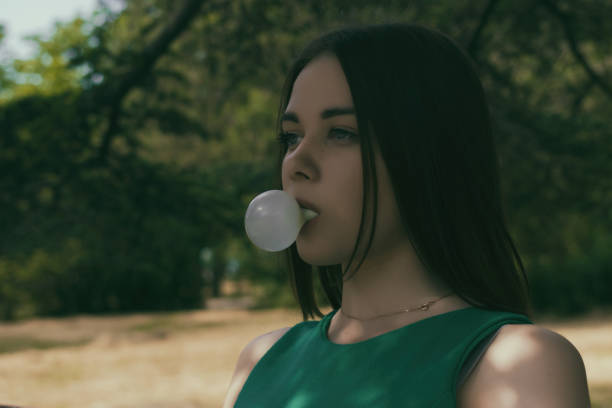 istock Young pretty girl chews a gum 695326080
