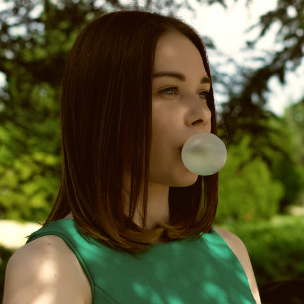 istock Young pretty girl chews a gum 695326100
