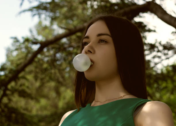 istock Young pretty girl chews a gum 695326342