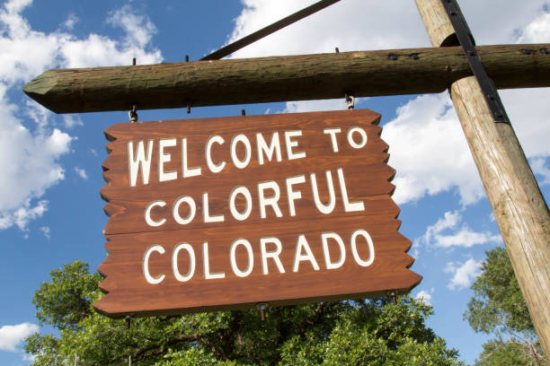istock Tilted Welcome to Colorful Colorado sign against sky 695328794