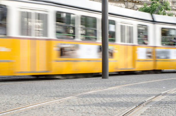 istock Blurred motion of Yellow tramway passing by on Buda side of Budapest 695331582