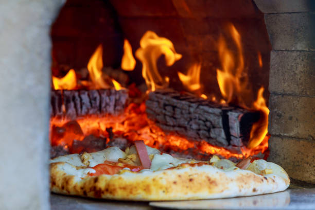 istock Flaming Hot Wood Fired Pizza Baking Oven 695332100