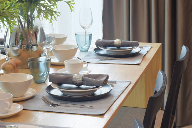 istock Gray and white tableware with jar of flower in dining room 695332282