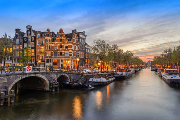 istock Amsterdam city skyline at canal waterfront when sunset, Amsterdam, Netherlands 695334630