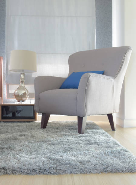 Gray upholstery armchair with blue pillow in modern interior living room stock photo