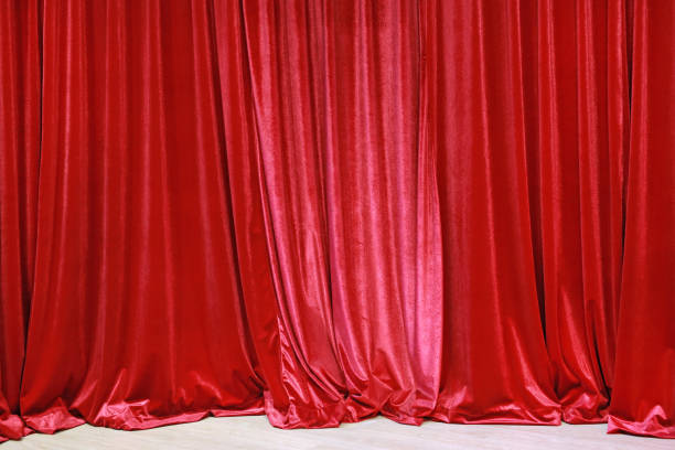 istock Red closed curtain background in a theater. 695337358
