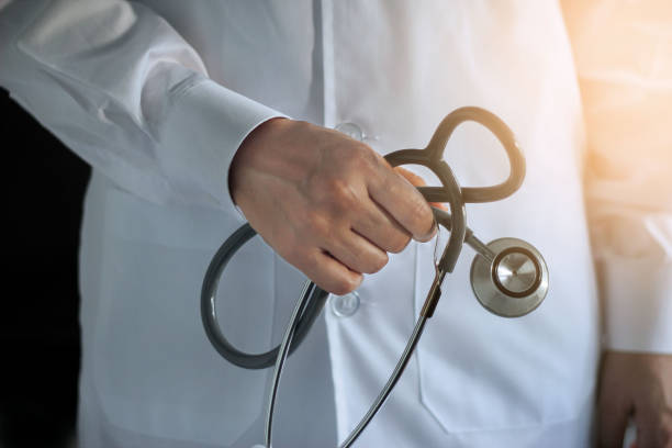istock Doctor with stethoscope in hand on hospital background 695337978