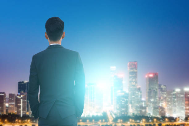 istock Businessman looking at city night 695341204