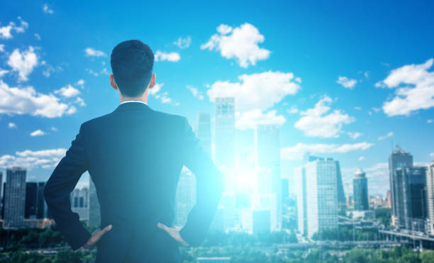 istock Businessman looking at cityscape 695341362