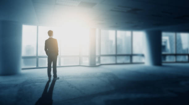 istock Businessman looking the city through office window 695343626