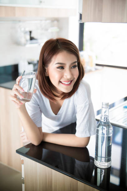istock relaxed young smiling woman drinking clean water 695343904