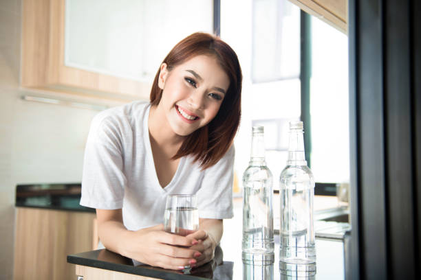 istock relaxed young smiling woman drinking clean water 695347552