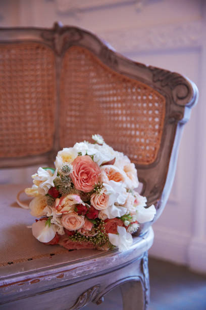 istock Brides bouquet lays on antique chair 695354268