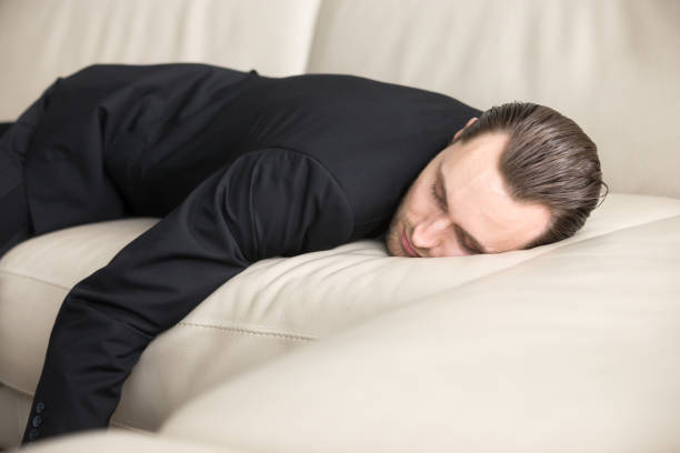 istock Tired businessman takes break for short sleep 695358956