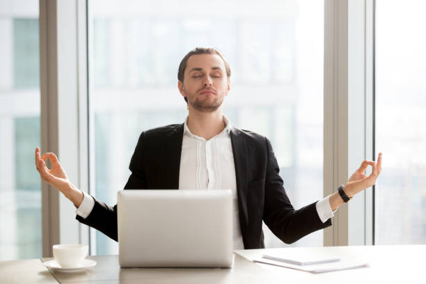 istock Businessman relieves work stress with meditation 695360624