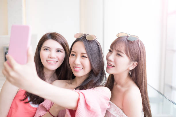 istock women selfie in mall 695361276