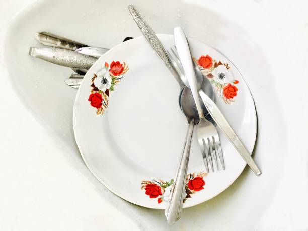 istock Porcelain Plate with Silverware in A Sink 695361958