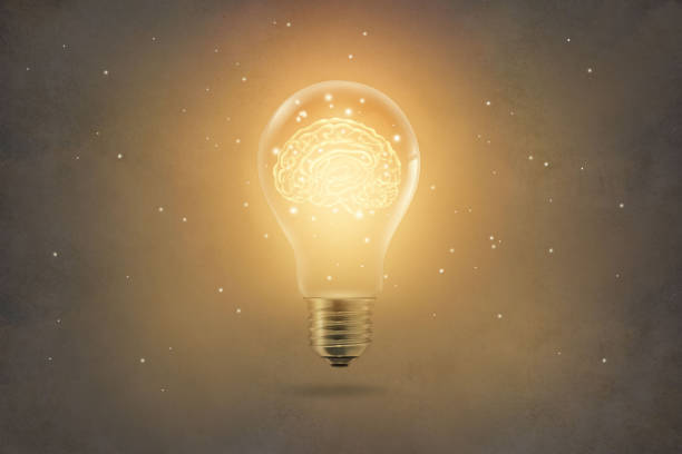 istock golden brain glowing inside of light bulb on paper texture background 695372164