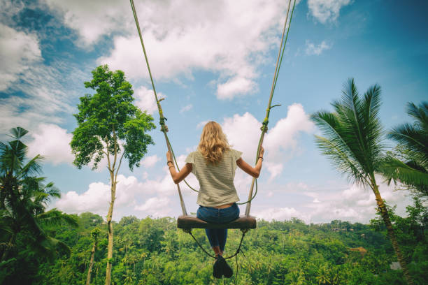 istock Young girl swinging in nature. 695372526