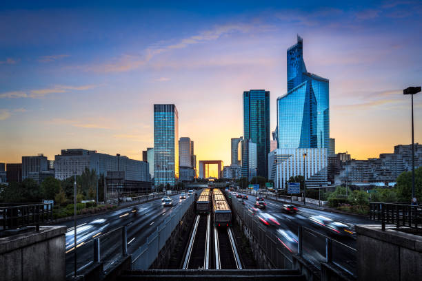 paris, view towards la defense financial district at sunset - blurred motion city life train europe imagens e fotografias de stock