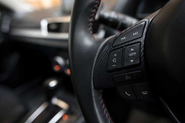 istock Control buttons on steering wheel in a modern car. soft focus. 695381130