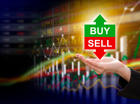 Business woman hand holding buy or sell on stock market background