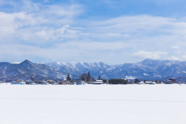 istock winter scenic with snow, mountain, and blue sky 695383654