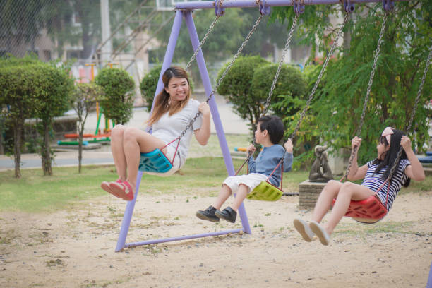 istock asian family swinging 695384300