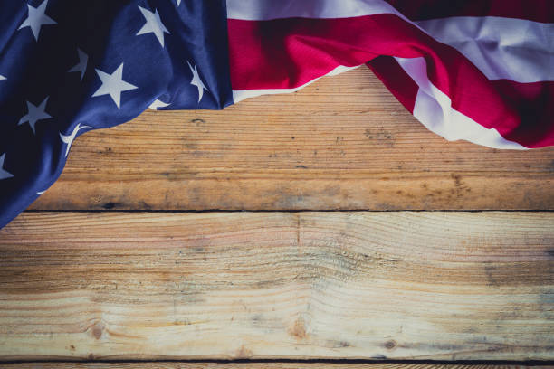 istock American flag on wooden background with copy space. 695386962