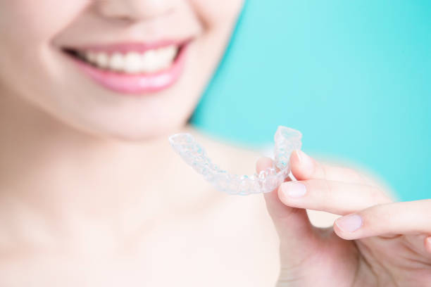 istock woman take invisible braces 695387618