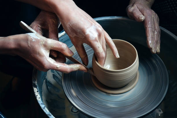 istock Master class on modeling of clay on a potter's wheel 695392744