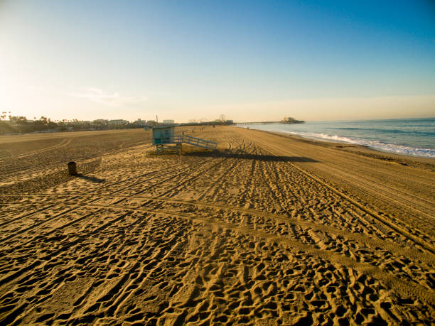 istock Lifeguard hut on sand at beach against sky 695397018