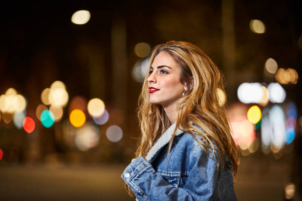 istock Thoughtful young woman looking away at night 695407494