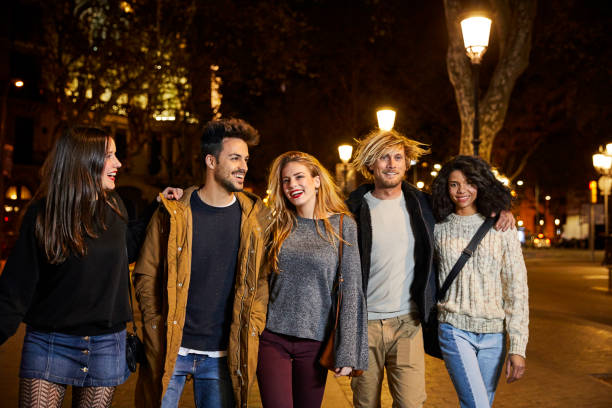 istock Smiling friends having leisure time at night 695407654
