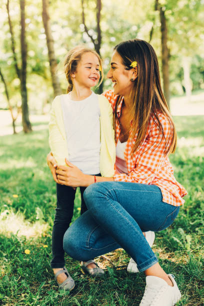 istock Mother and daughter in the park 695408242