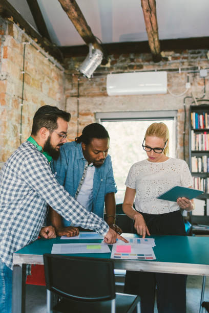istock Coworkers collaborating in the office 695414692