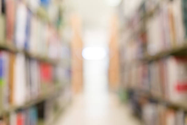 istock books on bookshelf in library, abstract blur defocused background 695415514