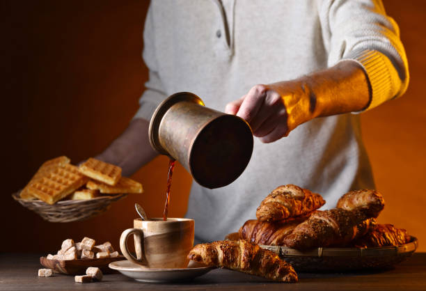 istock Breakfast with black coffee and fresh pastries 695434178