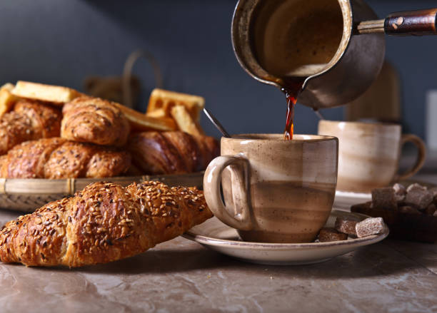istock Breakfast with black coffee and fresh pastries 695434208