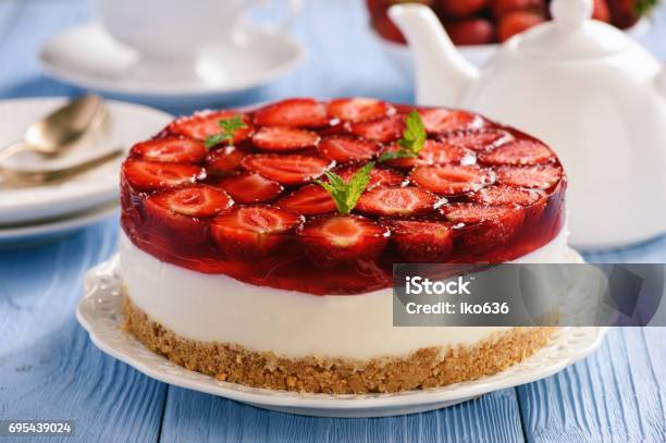 Homemade Strawberry Cheesecake On Blue Wooden Background Stock Photo - Download Image Now