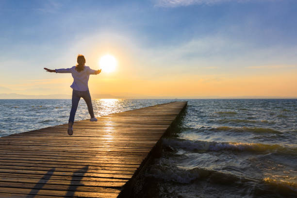istock Freedom – Woman on Lakeside Jetty 695439028