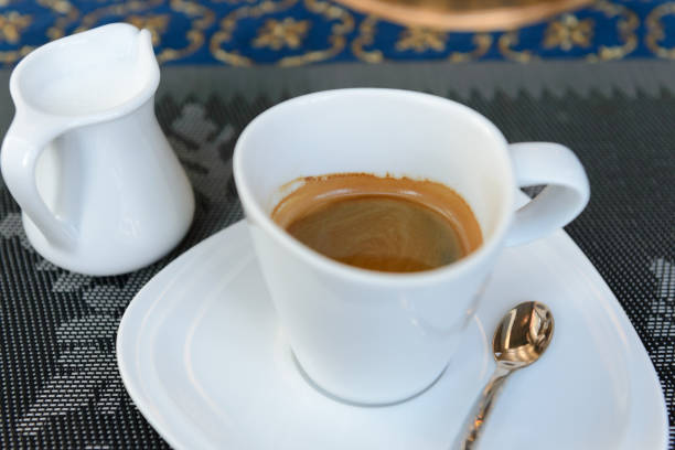 istock cup of hot coffee and milk on table. 695441490