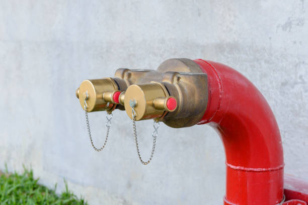 Fire hydrant manifold two outlet water valve. Fire department connection Fire hydrant manifold two outlet water valve. Fire department connection environmental pressure oven photos stock pictures, royalty-free photos & images