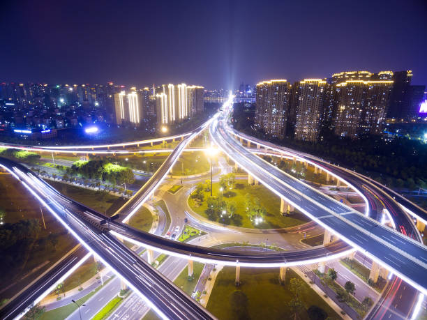 istock busy traffic on road intersection at night from top view. 695448274