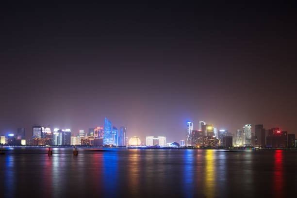 istock modern landmark buildings near water at night 695448434