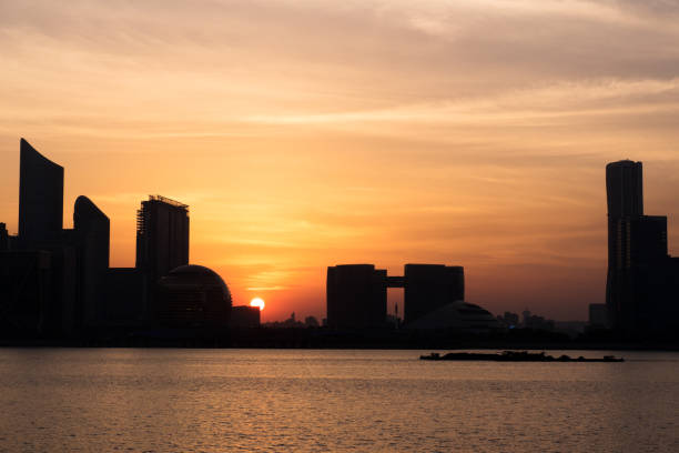istock modern buildings near water at sunrise 695448570