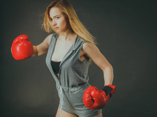 istock Beautiful woman with red boxing gloves 695448582