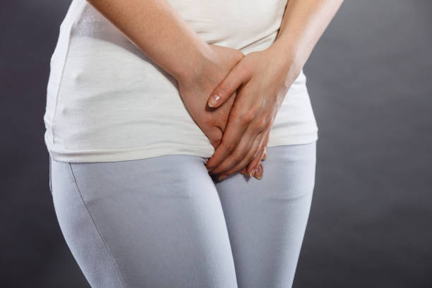 istock woman with hands holding her crotch 695448624