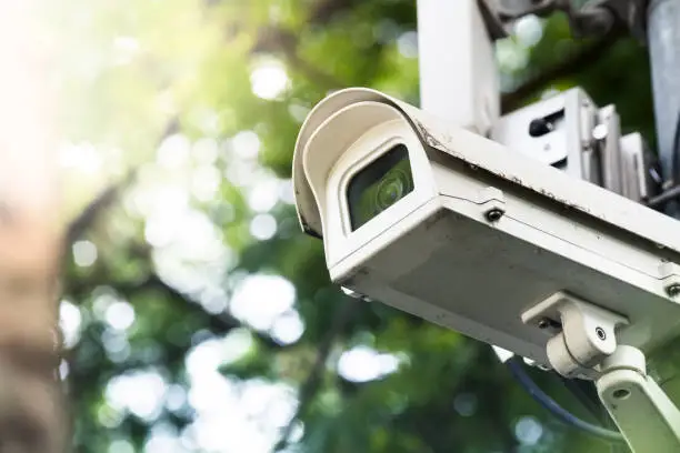 Photo of surveillance cctv camera security watching in outdoor garden park